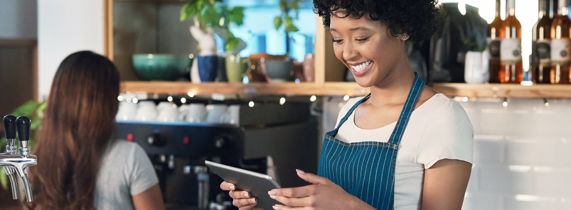Young woman in cafe processing payment